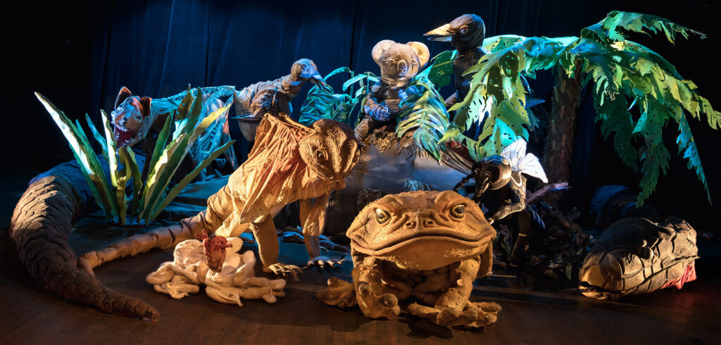 Eight giant Swamp puppets in a green forest