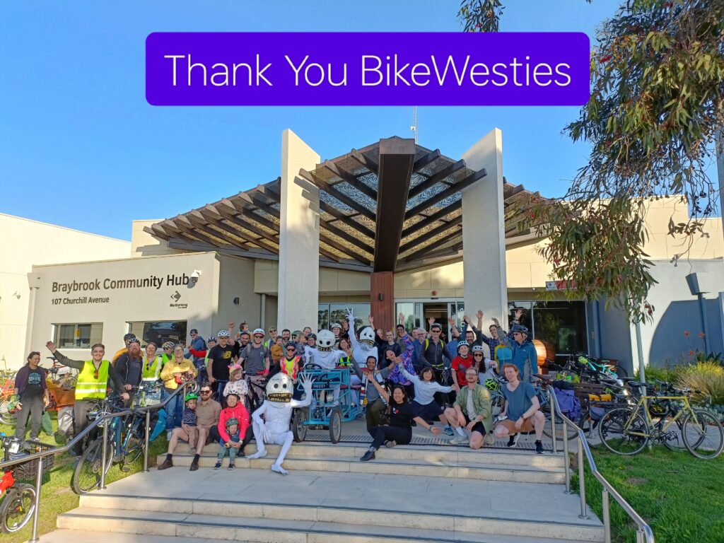 About 30 Bikewest riders and Skullies pose for a group photo on the steps of Baybrook Community Hub