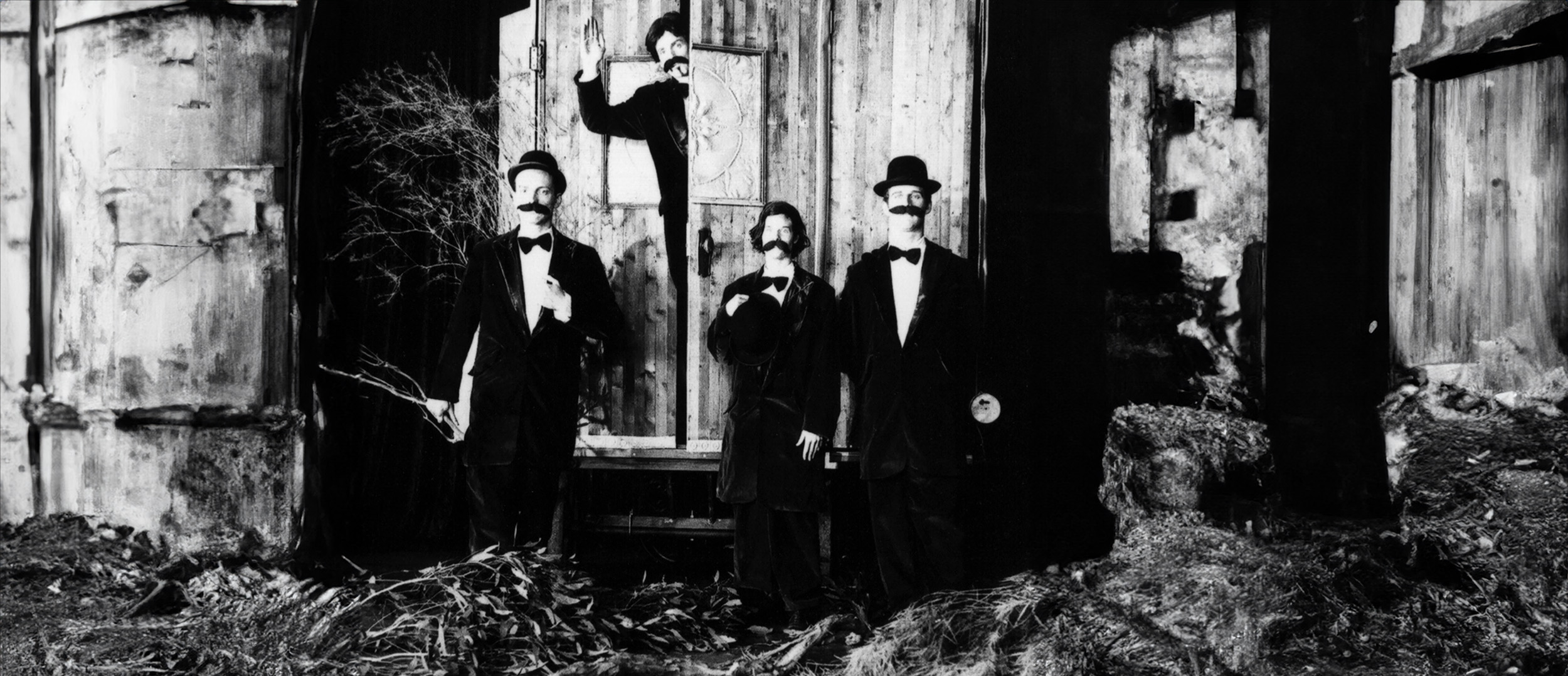 Snuff Puppets board image shows four people dressed up as men fron the 1910s